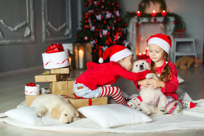 High angle view of girl playing with teddy bear at home