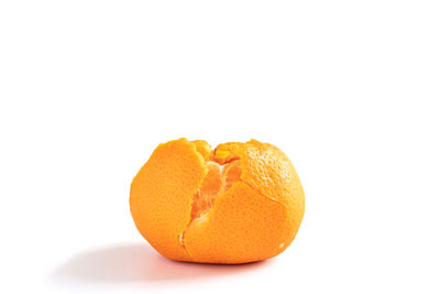 Close-up of orange fruit against white background