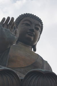 Low angle view of statue against temple against sky