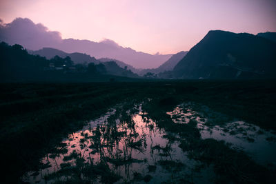 Scenic view of silhouette mountains against sky at sunset