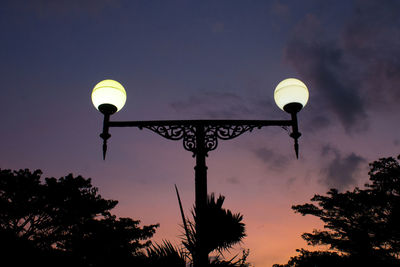 Low angle view of the streetlamp against sky towards sunset