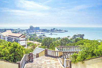 High angle view of buildings and sea against sky