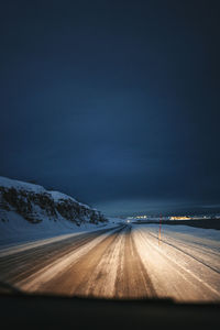 Empty road against sky at night