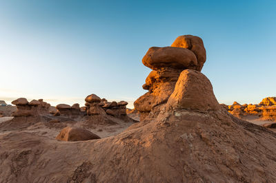 Hoodoos in goblin valley state park in utah, blue sky.