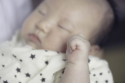 Close-up of baby sleeping on bed