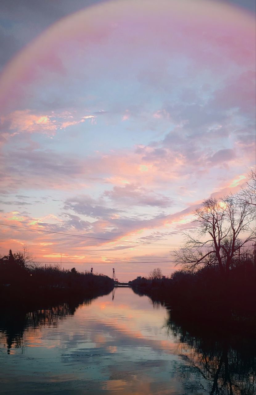 reflection, sky, water, beauty in nature, tranquility, scenics - nature, tree, cloud, sunset, tranquil scene, nature, dawn, plant, lake, no people, idyllic, evening, environment, silhouette, landscape, multi colored, non-urban scene, outdoors, orange color, sun, afterglow, pink, sunlight