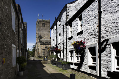 Alley amidst buildings against sky in city