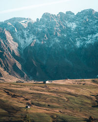 Scenic view of land and mountains against sky