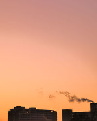 Low angle view of silhouette building against sky during sunset