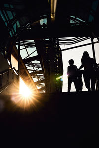 Silhouette men in sunlight