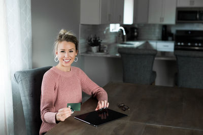 Portrait of a smiling young woman using smart phone