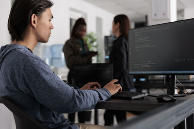 Young man using laptop at office