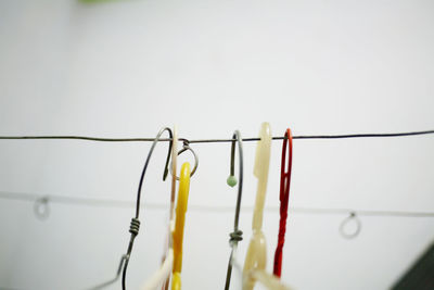 Low angle view of clothespins hanging on clothesline