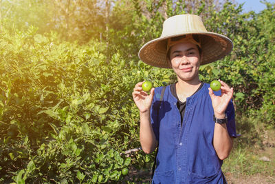 Portrait of smiling man standing against plants