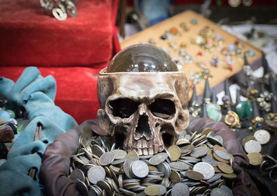 High angle view of human skull with coins on table