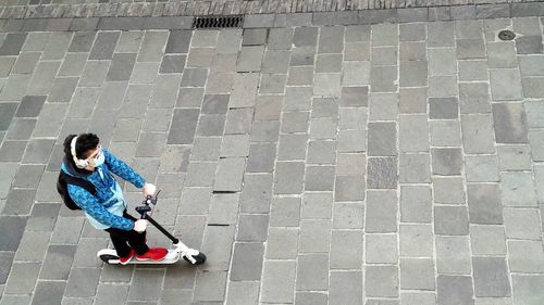 High angle view of woman walking on footpath