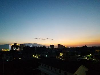 High angle view of illuminated buildings against sky during sunset