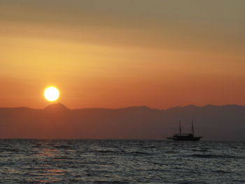 Scenic view of sea against orange sky