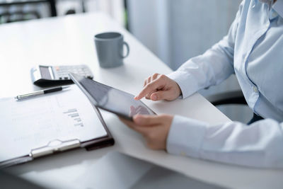 Midsection of doctor examining patient in clinic