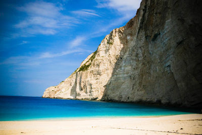 Scenic view of beach against blue sky