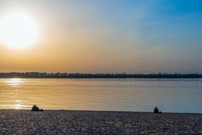 Scenic view of lake against sky during sunset