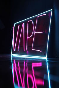 Close-up of illuminated text on black background