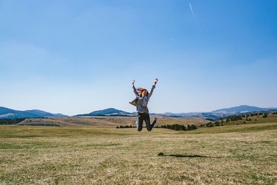 Young woman jumping on a field