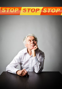 Full length of a man sitting on wall