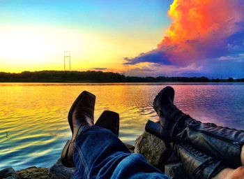 Low section of woman relaxing in lake