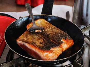 Brown grilled tuna fish cooking in pan