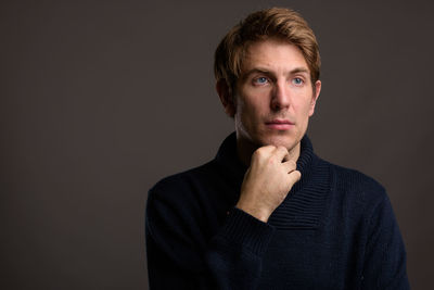 Portrait of mid adult man against black background