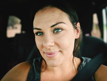 Close-up portrait of a smiling young woman