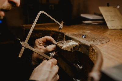 Close-up of hands working on table