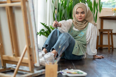 Portrait of cute girl sitting at home