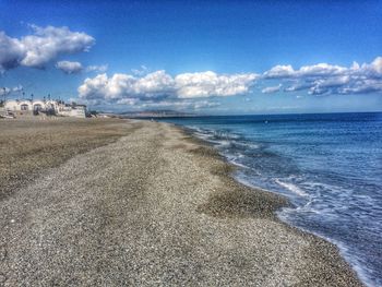 Scenic view of beach against blue sky