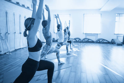 Full length of woman exercising in gym