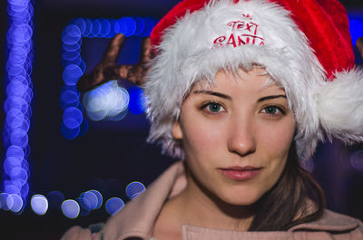 Close-up portrait of beautiful woman in santa hat