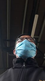 Low angle view of man wearing mask