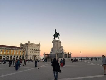 Statue in city against clear sky