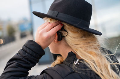 Side view of woman wearing hat