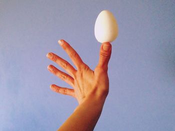 Low angle view of human hand against white background