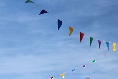 Low angle view of buntings hanging against sky