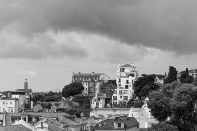 High angle view of buildings against cloudy sky