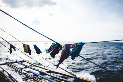 Clothes drying of rope at boat on sea