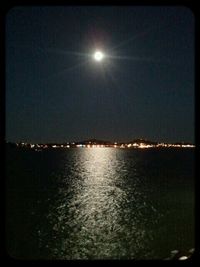 Reflection of trees in water at night