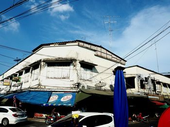 Low angle view of cars against sky in city