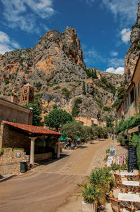 Sunny street with shops and restaurants at moustiers-sainte-marie, in the french provence.
