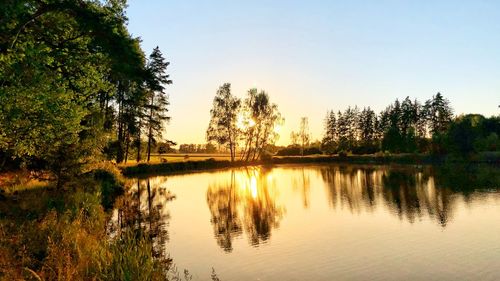 Scenic view of lake against sky during sunset