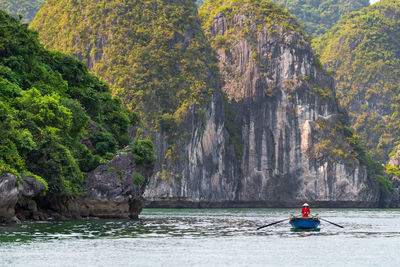 Man on rock by sea