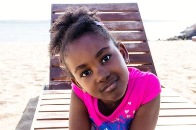 Portrait of young woman sitting on pier